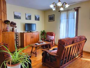 a living room with a couch and a tv at Casa Rural Mikelenea in Lecároz