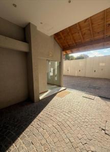an empty room with a brick floor and a building at Apartamento Monte Grande Ameghino in Monte Grande +4 photos