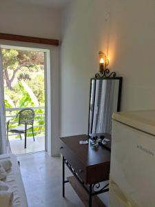 a room with a dresser and a mirror on a table at Ellia Mirtiotissa Rooms in Glyfada +32 photos
