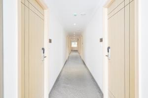 a hallway with white walls and a long aisle at Townhouse Oak AECS Layout Brookfield in Bangalore