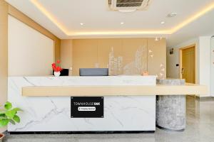 an office with a marble counter with a sign on it at Townhouse Oak AECS Layout Brookfield in Bangalore