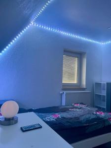 a bedroom with a bed and a desk with a computer at Stadtmitte Kitzingen in Kitzingen