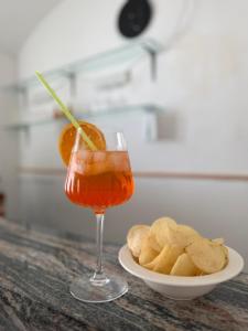 a drink with an orange and a plate of chips at Hotel Villa Porta All'Arco in Volterra +58 photos