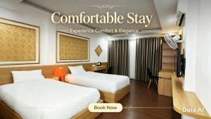 a hotel room with two beds and a desk at Hanoi Discovery Travel Hotel in Hanoi