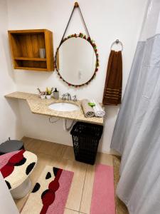 a bathroom with a sink and a mirror at Pousada Estância Bela Vista in Santa Teresa +52 photos