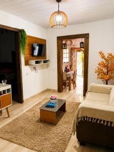 a living room with a couch and a coffee table at Pousada Estância Bela Vista in Santa Teresa