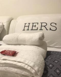 a pile of towels sitting on top of a bed at SPA apartman in Kragujevac +6 photos
