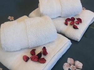 two towels with flowers on them on a table at SPA apartman in Kragujevac