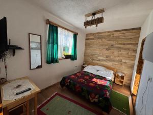 a bedroom with a bed and a desk with a computer at Casa Teodora in Albac +53 photos