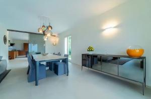 a kitchen with a table and a dining room at Cozy Villa with Pool in Como