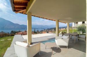 a patio with a table and chairs and a view at Cozy Villa with Pool in Como