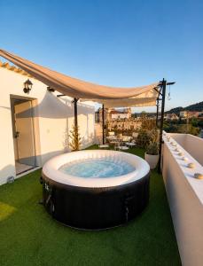 a hot tub on the roof of a house at Aris Studios in Karlovasi