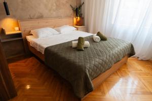 a bedroom with a bed with two stuffed animals on it at Casa Al Tramonto in Brestovi +26 photos