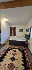 a bedroom with a bed and a rug at Ferienwohnung-Edna-Traunkirchen in Traunkirchen