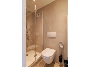 a bathroom with a toilet and a shower at Coastal Escape w Sauna in Zoutelande +34 photos