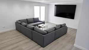 a living room with a couch and a flat screen tv at Chalet Laguna Place in Chipiona