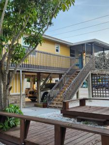 a house with stairs in front of a building at El Palmar Cottages LLC Whole House in Clearwater Beach