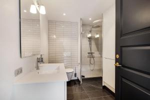 a white bathroom with a sink and a toilet at Hotel Varde Garten in Varde