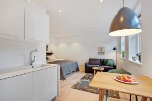 a kitchen and a living room with a table at Hotel Varde Garten in Varde +25 photos