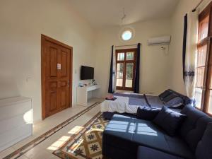 a living room with a couch and a bed at Ja guest house in Tel Aviv