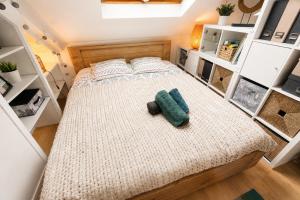 a bed in a small room with white shelves at Studio "En Coeur de Ville" - Proche Mairie et Quartier Perret - Calme et Charmant in Le Havre