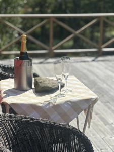 a table with a bottle of wine and two glasses at Lilla stugan Orust in Svanesund
