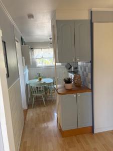 a small kitchen and dining room with a table at Lilla stugan Orust in Svanesund +4 photos