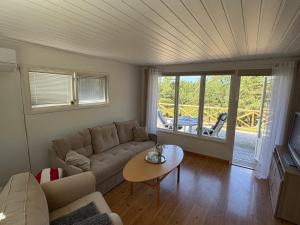 a living room with a couch and a table at Lilla stugan Orust in Svanesund