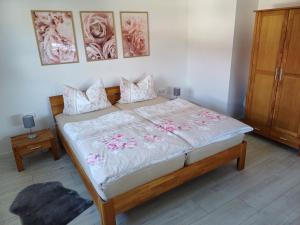 a bedroom with a large bed with flowers on it at Ferienwohnung BlumenMeer in Karlshagen