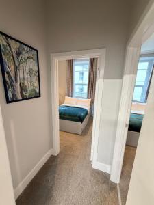a bedroom with a bed and a window at Homely Away in Plymouth +3 photos