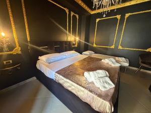 a bedroom with a large bed with golditures at XVI Secolo House in Scalea +33 photos