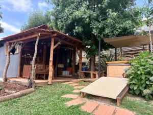 a small house with a porch and a bench in the yard at Casa das Fontes O Tocano in Válega +11 photos