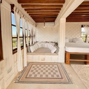 a bedroom with a bed and a large window at Kilele House in Lamu