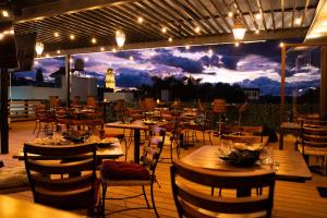a restaurant with tables and chairs on a deck at Kali Doña Tere in Acámbaro