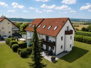 an aerial view of a white house with a red roof at Cosima in Hohenroth