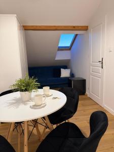 a room with a table and chairs and a couch at Villa Bianca in Mikołajki
