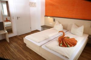 a hotel room with a bed with a pumpkin on it at Goldener Schlüssel mit Gästehaus Sina in Nördlingen