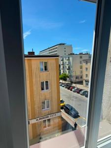a view of a building from a window at Apartament Dworcowa in Kołobrzeg +4 photos