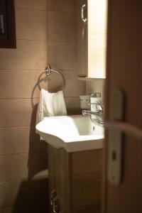 a bathroom with a white sink and a mirror at Solena Residences in Syvota +53 photos