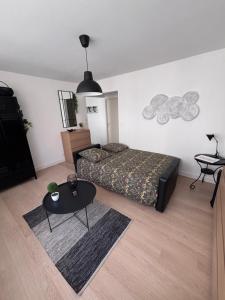 a bedroom with a bed and a table in it at Centre ville - Le Creusot in Le Creusot