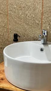 a white sink with a faucet on a counter at La Villa de los Alas - Boutique in Juayúa