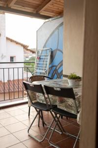 a table and chairs sitting on a balcony at Solena Residences in Syvota