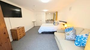 a living room with a couch and a bed at Parkside Lodge Hotel in Camelford