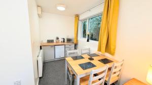 a kitchen and dining room with a table and chairs at Parkside Lodge Hotel in Camelford