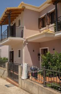 a house with clothes hanging on a fence at Solena Residences in Syvota