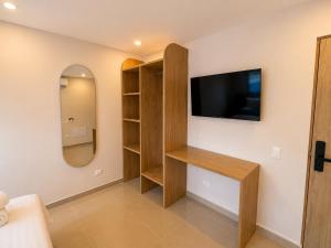 a living room with a tv on a wall at Hotel Azure Cartagena in Cartagena de Indias +40 photos