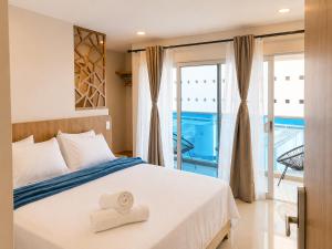 a bedroom with a bed with a towel on it at Hotel Azure Cartagena in Cartagena de Indias