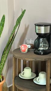 a coffee maker and saucers on a wooden shelf at La Villa de los Alas - Boutique in Juayúa +44 photos