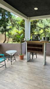 a patio with a table with a laptop on it at La Villa de los Alas - Boutique in Juayúa