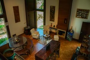 a living room with a table and chairs at Pousada Vila de Charme in Lençóis +124 photos